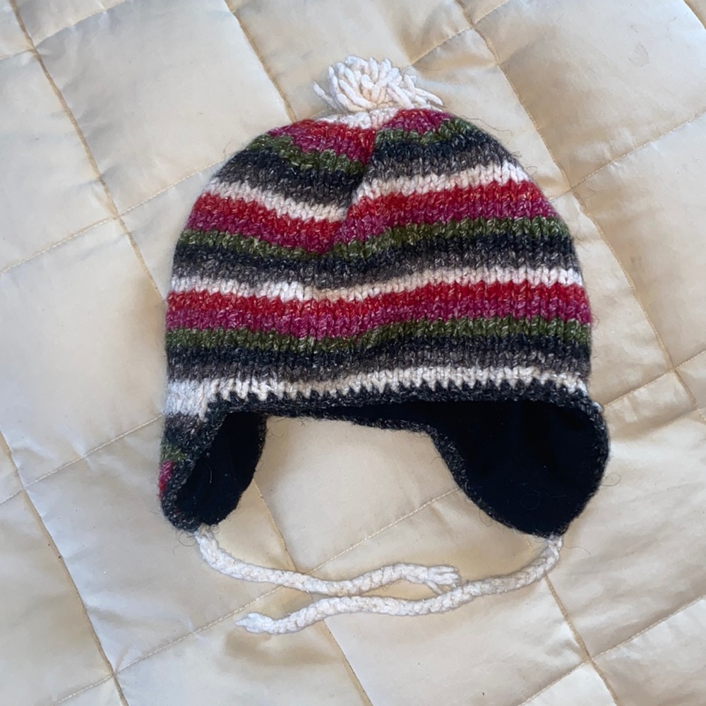 Winter hat w/ ear flaps and under chin tie. Ear & lower hat rim lined in fleece